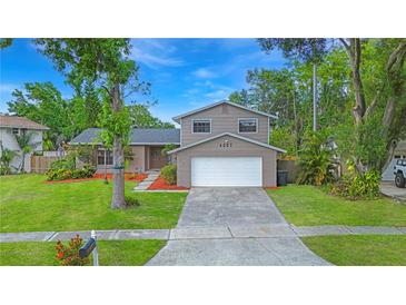 Charming two-story home with a well-maintained lawn, brick accents, and inviting curb appeal at 4207 Northwind Ln, Tampa, FL 33624
