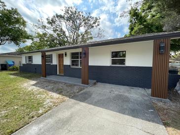 Single-story home features fresh exterior paint, new brick, new porch columns and a concrete driveway at 4415 Tuna Dr, Tampa, FL 33617