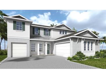 New construction home featuring a two-car garage, lush landscaping and a well-manicured lawn at 4483 Southern Valley Loop, Brooksville, FL 34601