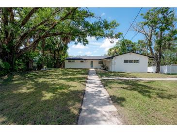 Charming one-story home featuring a well-manicured lawn and inviting walkway at 6108 Oak Ridge Ave, New Port Richey, FL 34653