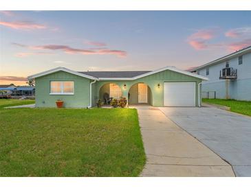 Charming single-story home with a well-maintained lawn and inviting curb appeal at 7401 Islander Ln, Hudson, FL 34667