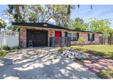 Cozy one story brick home with attached garage, mature trees, and unique decor at 7441 Cypress Dr, New Port Richey, FL 34653