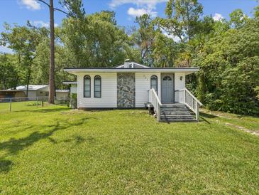 Charming single-story home with stone accents, gray front door, and a well-maintained lawn at 111 E Early St, Brooksville, FL 34601