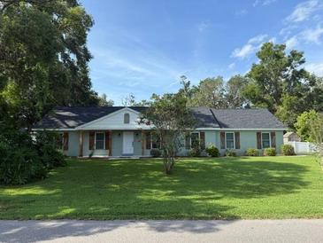 Charming single-story home with a well-maintained lawn and mature trees, offering great curb appeal at 2005 Capri Rd, Valrico, FL 33594