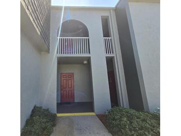 Exterior view of building entrance featuring covered walkway and upper floor balcony at 3123 29Th N Ave # 105, St Petersburg, FL 33713