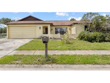 Single-Gathering home featuring an attached one-car garage and a traditional mailbox at 7018 Arbor View Ln, New Port Richey, FL 34653