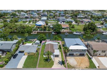 Charming waterfront home with lush landscaping, a private boat dock, and canal access at 4059 Orient Dr, Hernando Beach, FL 34607