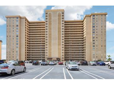 Spacious condo building exterior with parking lot and a neutral color palette on a sunny day at 5200 Brittany S Dr # 1501, St Petersburg, FL 33715
