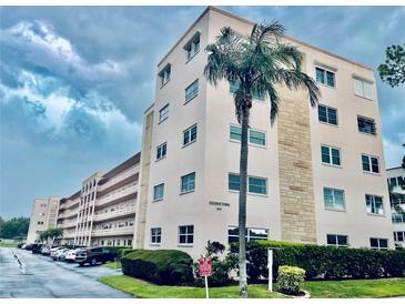 Multi-story condo complex with well-maintained landscaping and dedicated parking at 5623 80Th N St # 406, St Petersburg, FL 33709