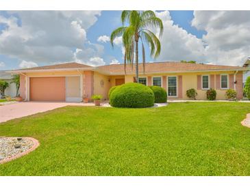 Charming single-story home featuring a lush green lawn and well-manicured landscaping at 608 Fort Duquesna Dr, Sun City Center, FL 33573