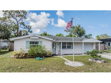 Charming single-story home featuring a well-maintained lawn and welcoming facade at 5414 Oceanic Rd, Holiday, FL 34690