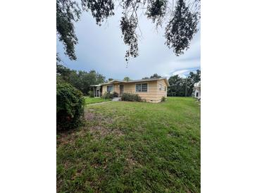 Charming single-story home featuring a screened porch, mature trees, and a spacious front yard at 5631 23Rd S Ave, Gulfport, FL 33707