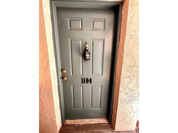 Exterior front door of unit 1104 with a lockbox for convenient access at 720 Lyndhurst St # 1104, Dunedin, FL 34698
