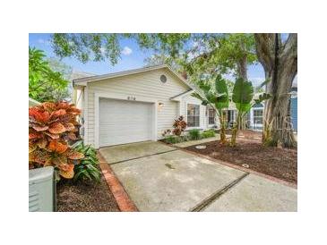 Charming single Gathering home features an attached garage and mature landscaping at 878 Franklin Cir, Palm Harbor, FL 34683