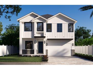 New construction home with white siding, black trim, two-car garage, and a stone base at 905 N Willow Ave, Tampa, FL 33606