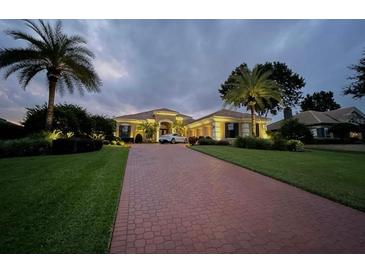 Spacious single-story home with a large driveway, mature landscaping, and great curb appeal at 12713 Grand Traverse Dr, Dade City, FL 33525