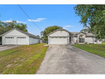 Charming single-story home with attached and detached two-car garages at 13991 Coronado Dr, Spring Hill, FL 34609
