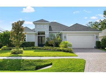 Beautifully landscaped front yard featuring a well-manicured lawn and lush tropical plantings surrounding the elegant home at 15415 Otto Rd, Tampa, FL 33624