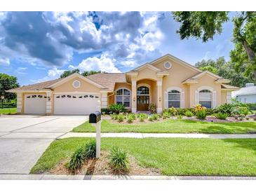 Charming single Gathering home with manicured lawn and three car garage at 17302 Stetson Ln, Odessa, FL 33556