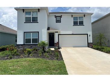Charming two-story home featuring manicured landscaping and a well-maintained lawn in a desirable neighborhood at 17807 Canopy Pl, Bradenton, FL 34211