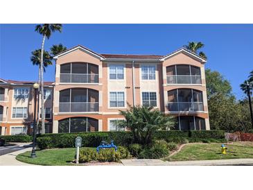 Three-story condo building with screened patios and lush landscaping at 5000 Culbreath Key Way # 1-220, Tampa, FL 33611