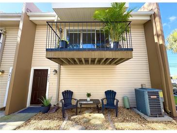 Charming townhouse with a private balcony, cozy seating area, and well-maintained exterior at 5423 Sweetwater Terrace Cir, Tampa, FL 33634