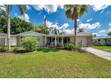 Charming single-story home featuring a well-manicured lawn, stone accents, and a welcoming front entrance at 5936 13Th Ave, New Port Richey, FL 34652