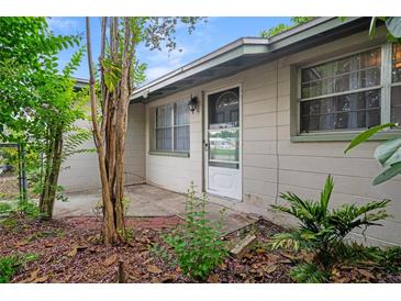 Charming single-story home featuring a bright front entrance and mature landscaping at 6006 Axelrod Rd, Tampa, FL 33634