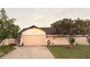 Charming single-story home with a well-maintained lawn and two-car garage at 7031 Drury St, Tampa, FL 33635