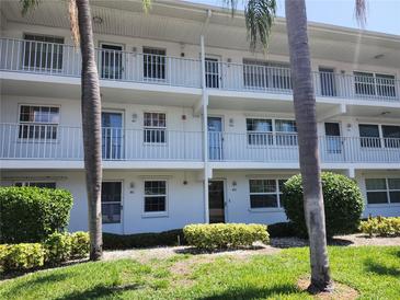 Condo building featuring multiple units with balconies and well maintained landscaping at 802 Brandy Wine Dr # 802, Largo, FL 33771