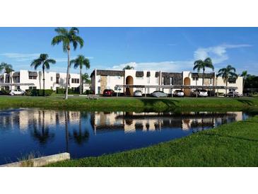 Beautiful condo community with lush landscaping and canal views offering covered parking for all residents at 221 Fernwood Cir # 221, Seminole, FL 33777