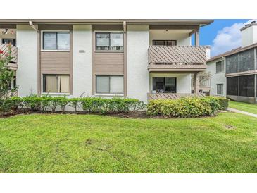 Two story condo building featuring well maintained lawn and landscaping at 2368 Flanders Way # D, Safety Harbor, FL 34695