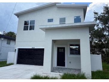 Modern two-story home with a black garage door and neutral-colored stucco exterior at 2404 Cassell St, Tampa, FL 33605