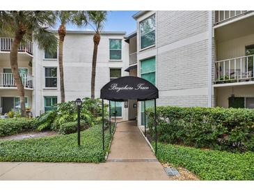 Inviting condo complex entrance with well-manicured landscaping and covered walkway at 3325 Bayshore Blvd # A31, Tampa, FL 33629