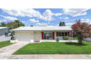 Charming single-story home with a well-manicured lawn and bright red shutters at 3515 100Th N Ter, Pinellas Park, FL 33782