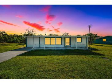 Charming single-story home showcasing well-maintained lawn and vibrant sunset colors at 3614 Vasco St, Punta Gorda, FL 33950