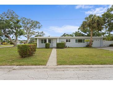 Charming single-story home with well-maintained lawn and mature trees, offering curb appeal at 4300 Maple Ne St, St Petersburg, FL 33703