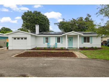 Charming home with solar panels, bright shutters, neat landscaping, and covered entry at 4753 58Th N St, Kenneth City, FL 33709