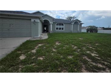 Charming single Gathering home with an attached two car garage and quaint landscaping at 7056 Landover Blvd, Spring Hill, FL 34608