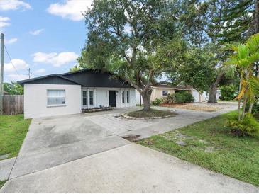 Charming single-story home with a large tree in the front yard at 8233 44Th St N N St, Pinellas Park, FL 33781