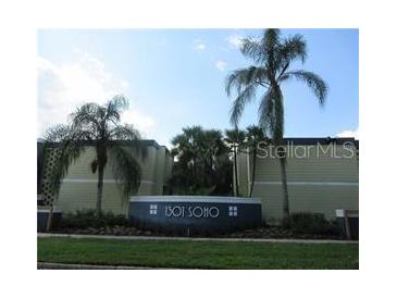 Exterior view of building entrance with mature palm trees at 1301 S Howard Ave # C4, Tampa, FL 33606
