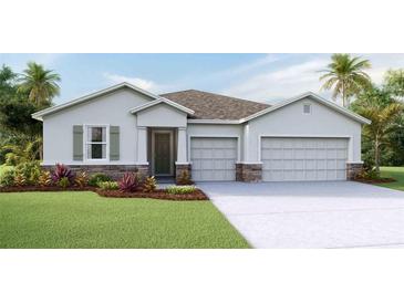 Inviting single-story home with a two-car garage, stone accents, and a well-manicured lawn at 19669 Gladeview Way, Land O Lakes, FL 34638