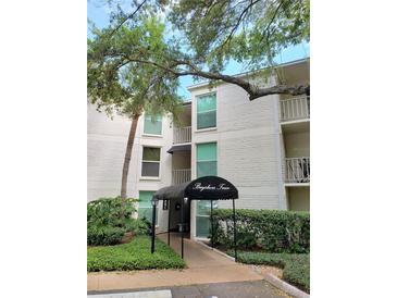 Exterior of a white building with the name Bayshore Trace over the entrance and well-manicured landscaping at 3325 Bayshore Blvd # C14, Tampa, FL 33629