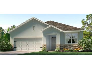 Charming single-story home with a two-car garage, stone accents, and manicured landscaping at 3340 Ivy Hollow Dr, Plant City, FL 33565