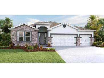 Charming home featuring a stone facade, arched entryway, three-car garage and well-manicured lawn at 4019 Harvest Hearth Pl, Plant City, FL 33565