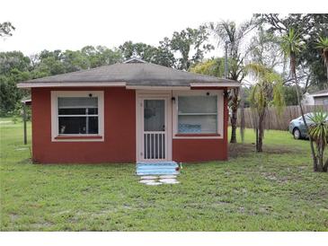 Charming single-story home featuring a cozy front porch and well-maintained lawn at 1006 Gray St, Plant City, FL 33563