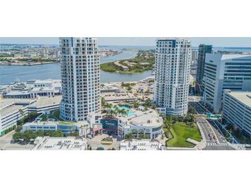 Stunning aerial view of waterfront towers and resort-style pool with city and water views at 1209 E Cumberland Ave # 2703, Tampa, FL 33602