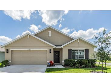 Charming single-story home features a two-car garage and well-maintained landscaping, perfect for curb appeal at 13304 Mylion Way, Spring Hill, FL 34610
