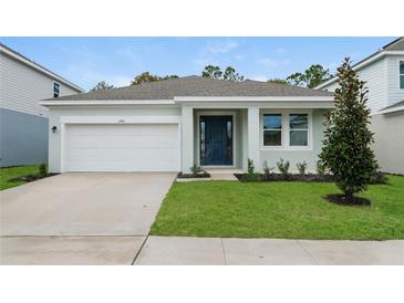 Charming one-story home featuring a two-car garage, manicured lawn, and welcoming front entry at 2791 Peake St, North Port, FL 34286