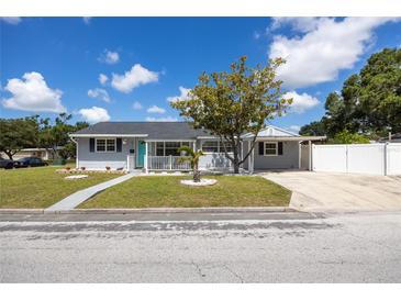 Charming single-story home with well-maintained lawn, complemented by lush landscaping and inviting curb appeal at 400 53Rd N St, St Petersburg, FL 33710